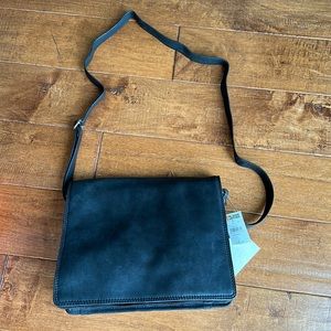 Black leather Crossbody tote with fold over flap. Brand is Wilson leather.